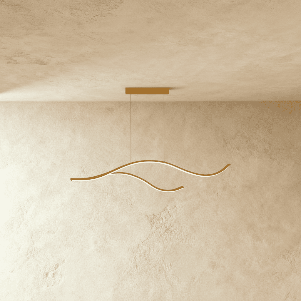 Clérachic gold two-arc wavy LED pendant, lit along its slim curves, hung from a small gold canopy on twin cables.