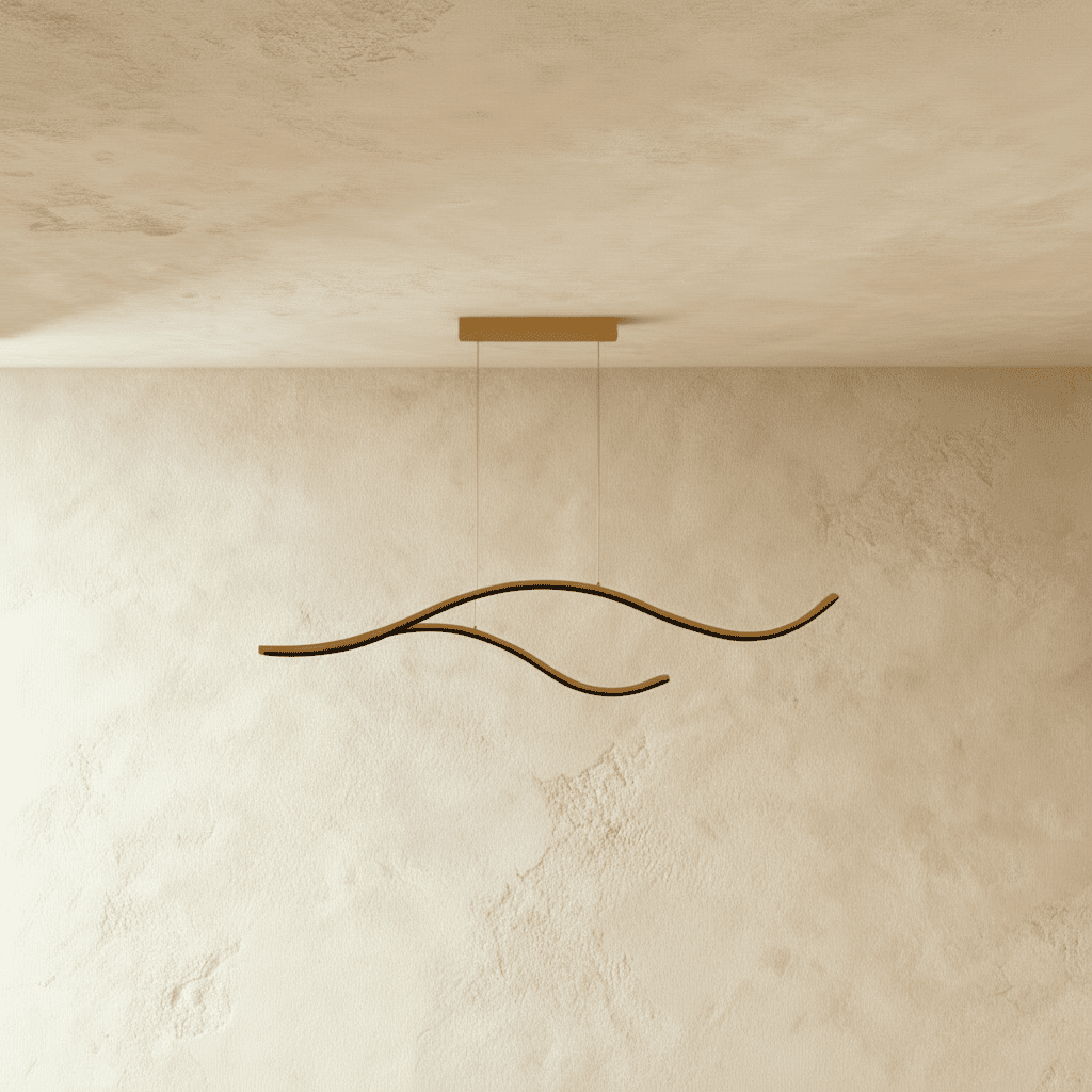 Clérachic gold two-arc wavy LED pendant shown unlit, its brushed aluminium curves hanging below a slim gold canopy.