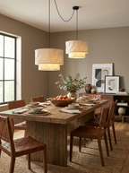 As a staggered cascade, this Clérachic pendant lights a dining table styled with a fruit bowl and sideboard.