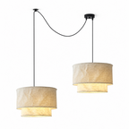 This Clérachic pendant shown as a cascade pair, dropping from wandering black cords on a plain backdrop.