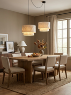 Above a dining table set with a floral centrepiece and matching sideboard, this Clérachic pendant hangs as a cascade pair.