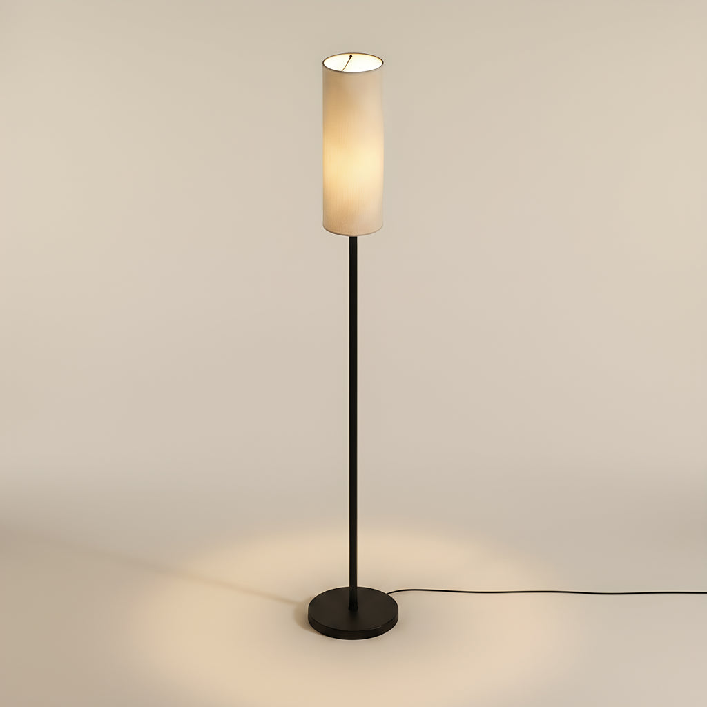 The same lamp from a raised camera, looking down into the open top of the linen shade with the round base reading as a full ellipse