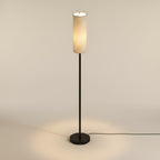 The same lamp from a raised camera, looking down into the open top of the linen shade with the round base reading as a full ellipse
