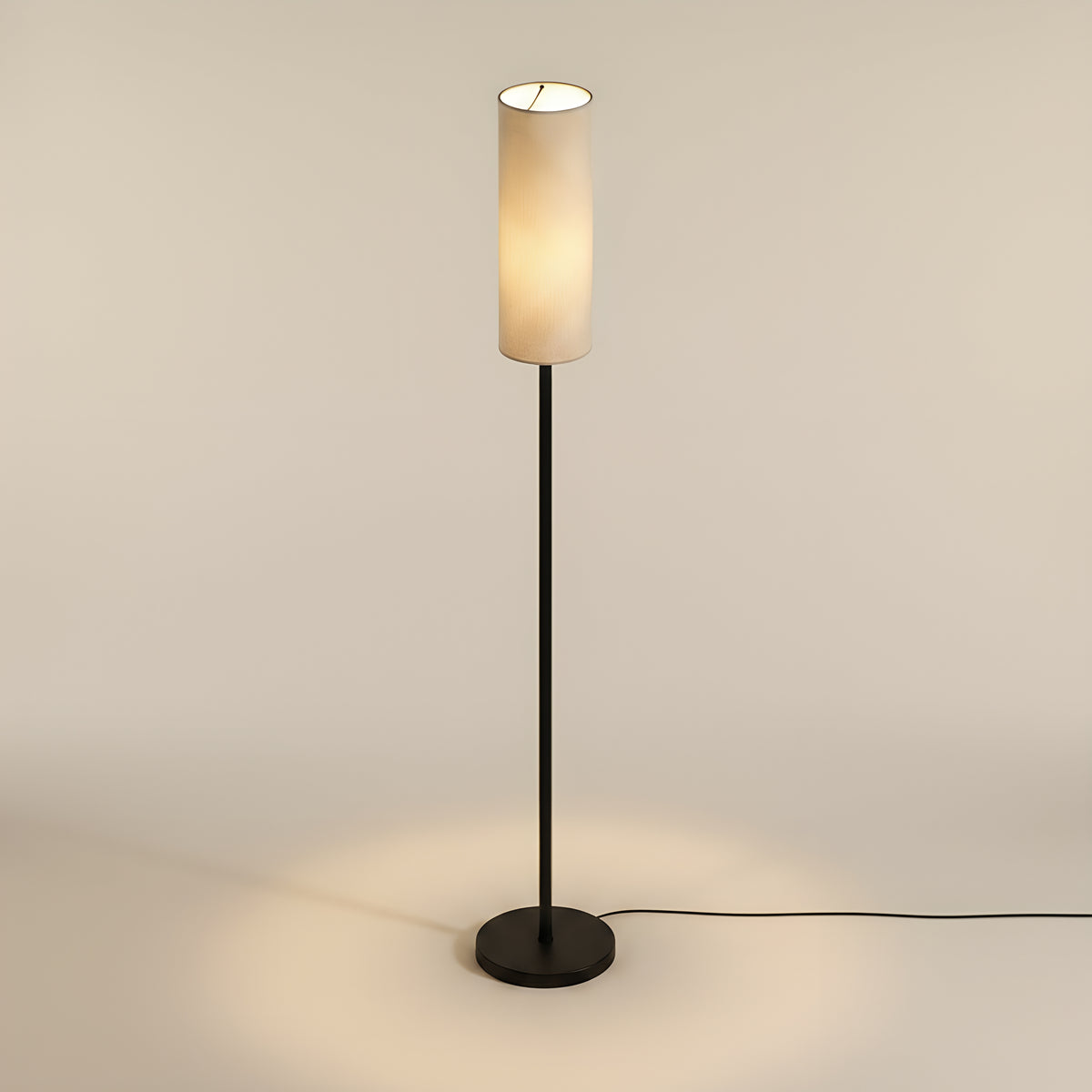 The same lamp from a raised camera, looking down into the open top of the linen shade with the round base reading as a full ellipse