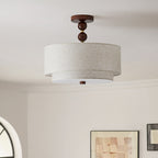 Clérachic double-cylinder ceiling light in walnut and linen, unlit, with a framed abstract print at the bottom of the frame.