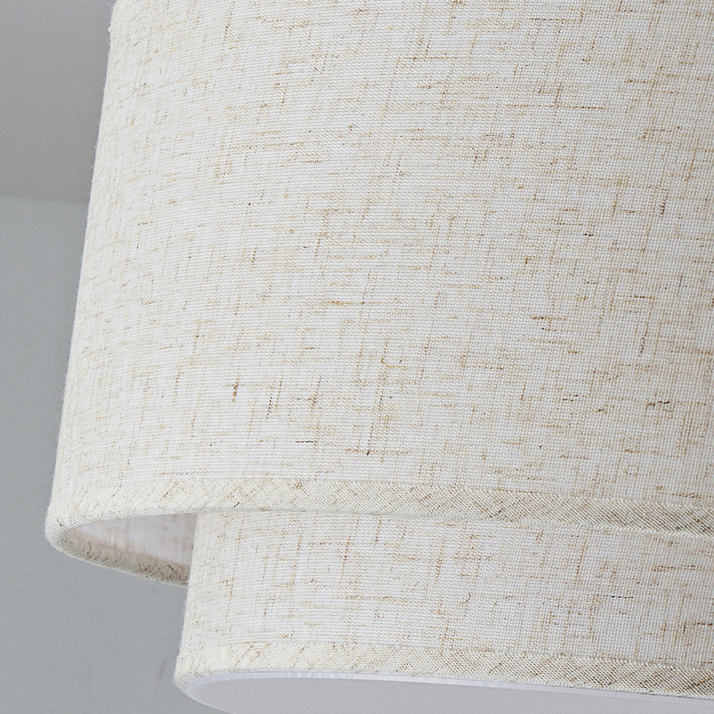 Close view of the loose, flecked linen weave on the two stacked shades of this Clérachic ceiling light.