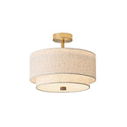 Larger view of the gold and linen Clérachic flush-mount light, with its two linen tiers and a small walnut finial at the base.