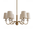 Six-light gold Clérachic chandelier with linen shades and ceramic necks, hanging from a straight rod on a white background.