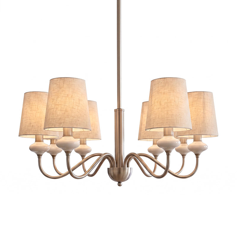 Lit six-light Clérachic chandelier with linen shades and looping arms, shown in a soft sepia tone on white.