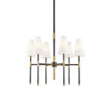 This Clérachic six-light chandelier in black and brass, shown on a plain white backdrop with the tapered linen shades facing up.