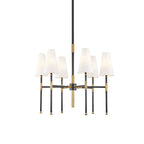This Clérachic six-light chandelier in black and brass, shown on a plain white backdrop with the tapered linen shades facing up.