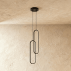 Clérachic double black oval loop pendant with two overlapping rings, unlit, on cords from a round black canopy.