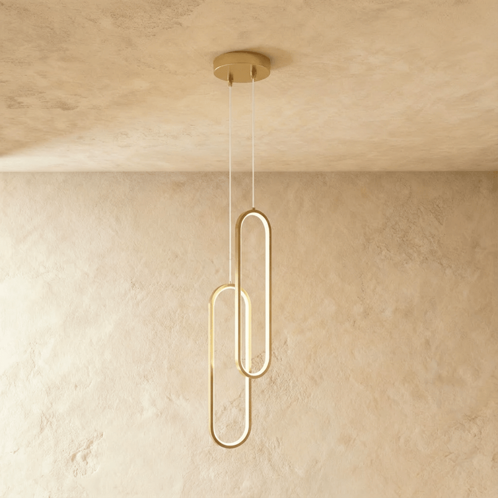 Clérachic double brushed gold oval loop pendant, two linked LED rings glowing on clear cords from a gold canopy.