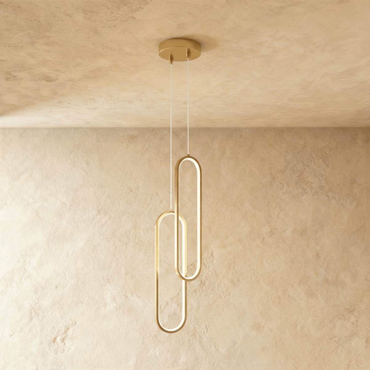 Clérachic double brushed gold oval loop pendant, two linked LED rings glowing on clear cords from a gold canopy.