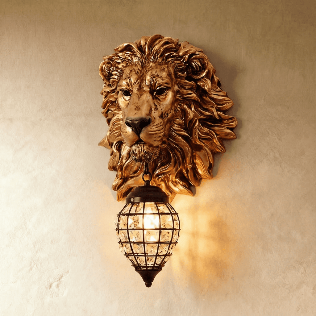 Clérachic gold lion head sconce with a caged crystal lantern lit warm, shown straight on against a textured plaster wall.