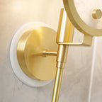 The Clérachic sconce detail showing the brass ring and stem meeting the round alabaster backplate in warm light.
