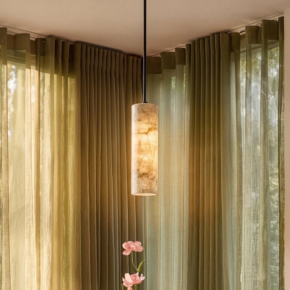 Clérachic alabaster cylinder pendant glowing in a window corner with sage linen curtains, its veining warmly lit.