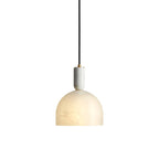 The Clérachic Long-Drop Dome pendant light on white, an alabaster dome under a stone stem capped with brushed brass discs.