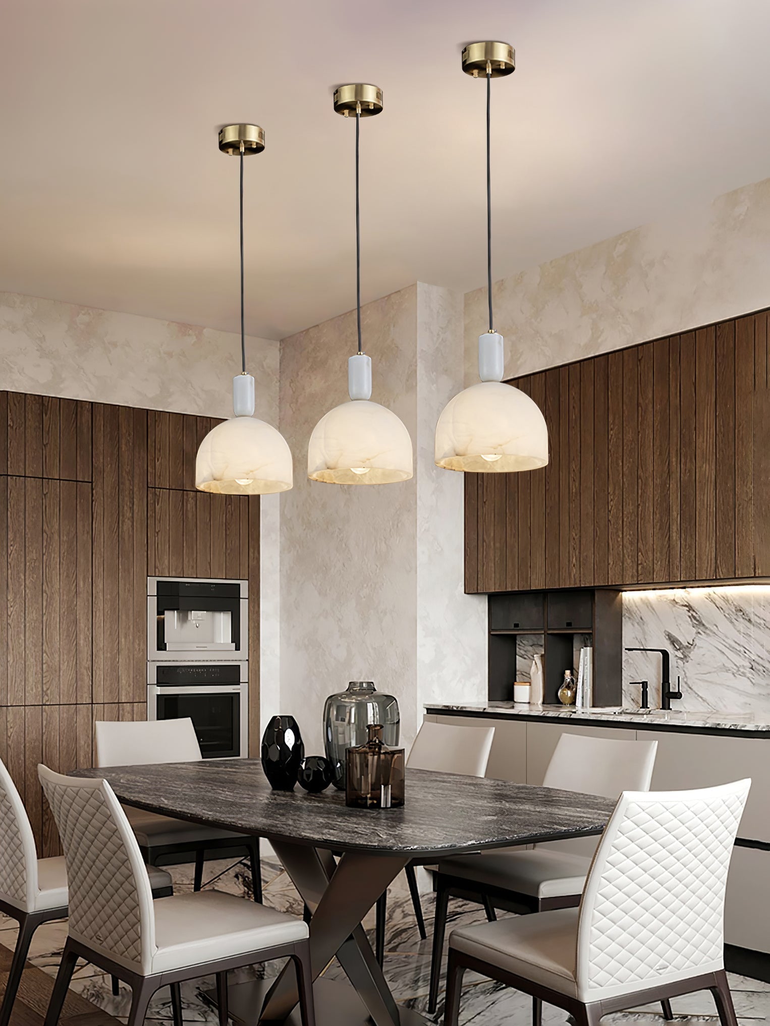 Three Clérachic Long-Drop Dome pendant lights lit in a row above a dining table in a walnut and marble kitchen.