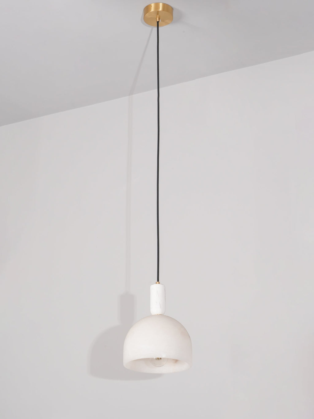 Full drop of the Clérachic Long-Drop Dome pendant light, brass ceiling canopy to shade down a long black cord.