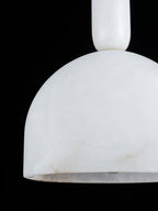 Extreme close-up of the Clérachic Long-Drop Dome pendant light shade, cloudy alabaster veining against black.