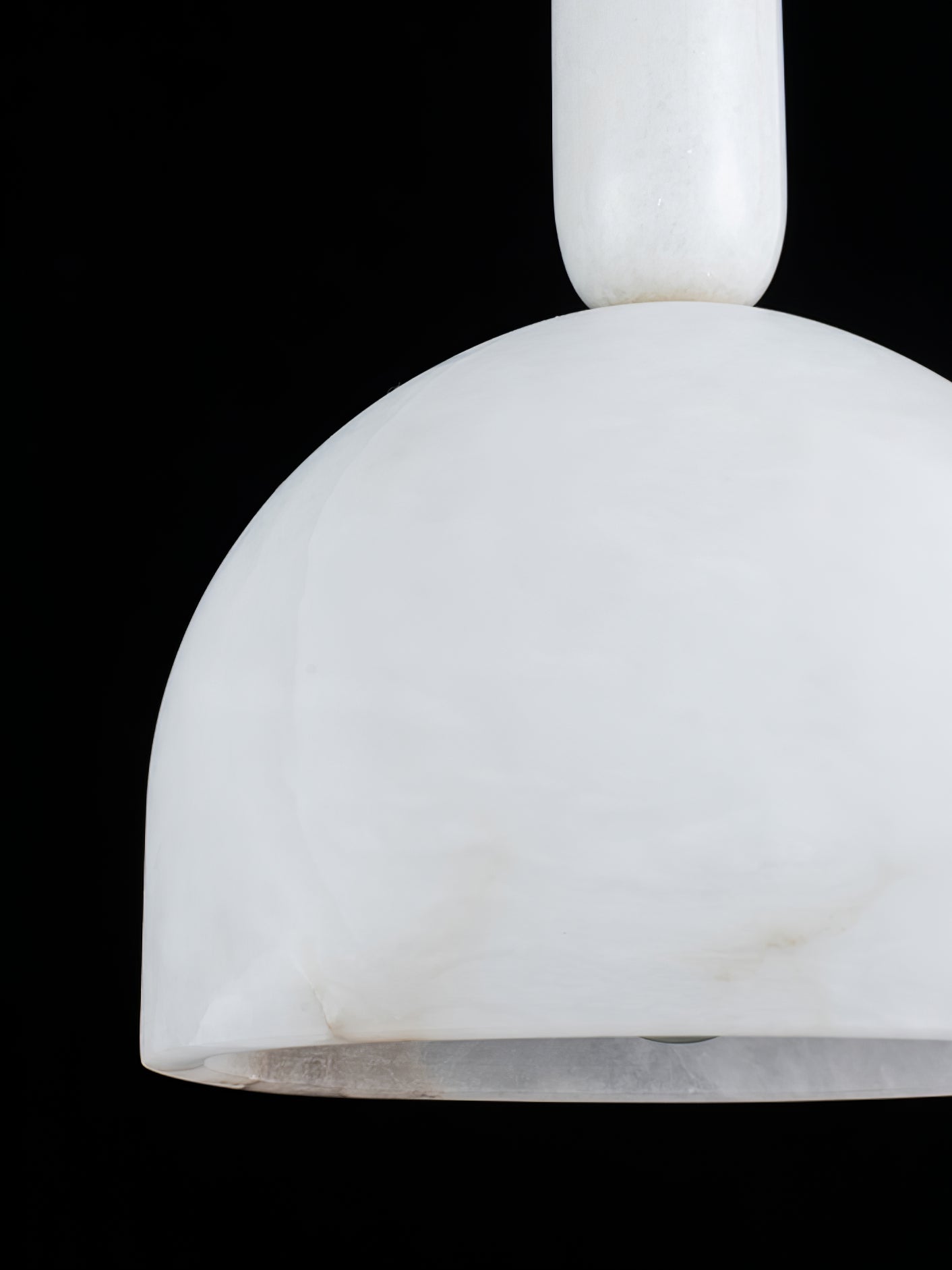 Extreme close-up of the Clérachic Long-Drop Dome pendant light shade, cloudy alabaster veining against black.