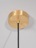 The round brushed brass ceiling canopy of the Clérachic Long-Drop Dome pendant light, black braided cord below.