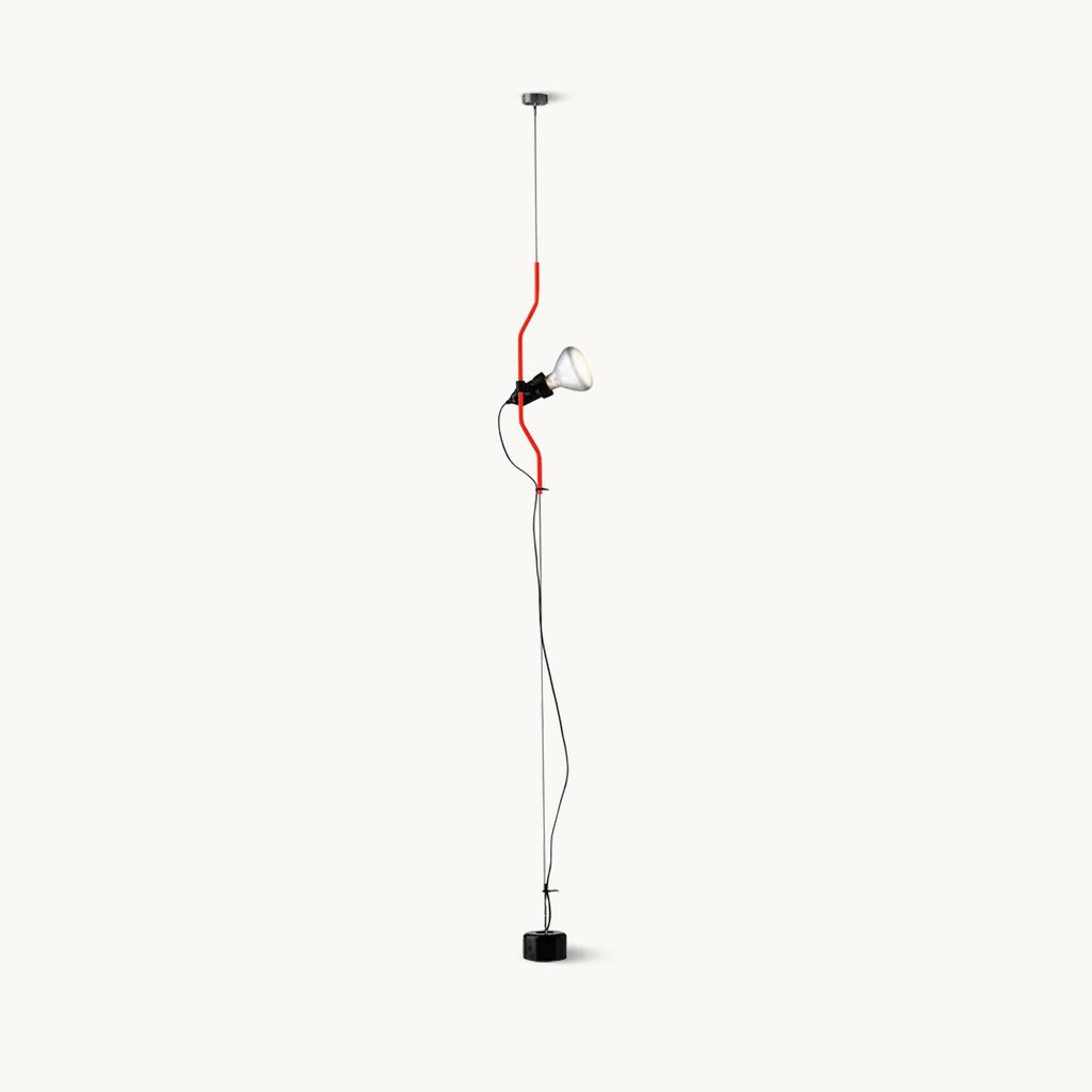 Clérachic long-drop pendant light with a red bendable cord section, a black spotlight head and a weighted black floor base, on white.