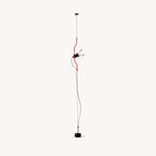 Clérachic long-drop pendant with a red bendable cord section, a black spotlight head and a black base, on a pale backdrop.