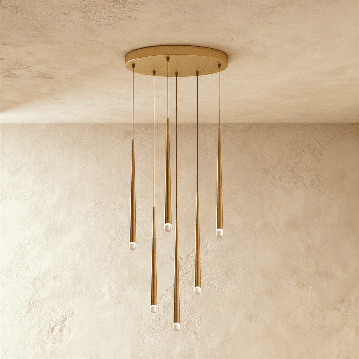 Clérachic six-light gold cone pendant cluster on an oval canopy, slender tapered tubes with crystal tips at varied heights.