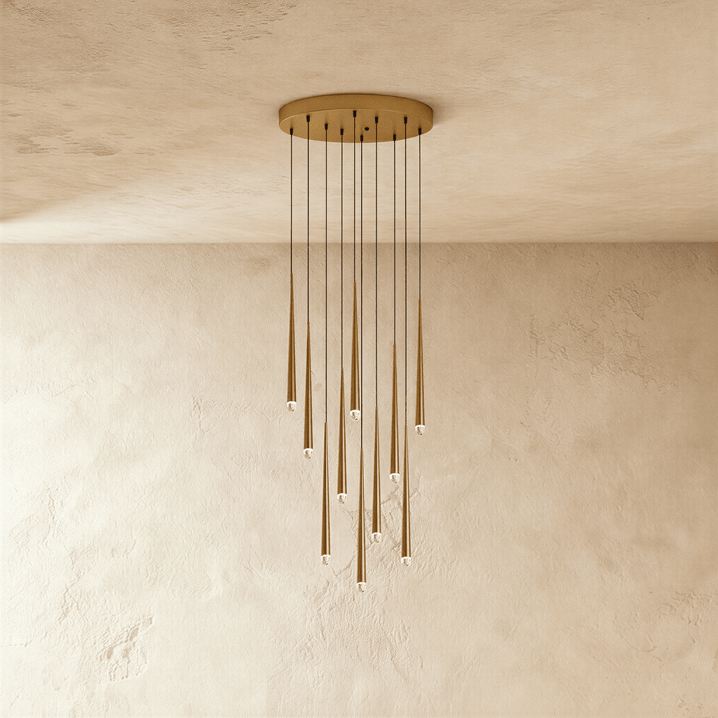 Clérachic ten-light gold cone pendant cluster on a round canopy, slim tapered tubes with crystal tips falling at staggered lengths.