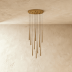 Clérachic ten-light gold cone pendant cluster on a round canopy, slim tapered tubes with crystal tips falling at staggered lengths.