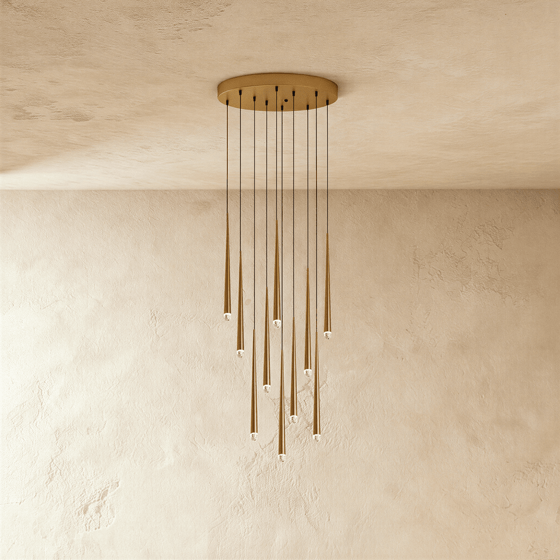 Clérachic ten-light gold cone pendant cluster on a round canopy, slim tapered tubes with crystal tips falling at staggered lengths.