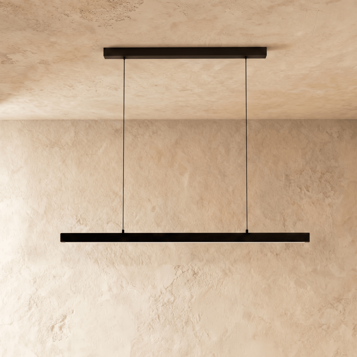 Clérachic black linear pendant light hangs centred, its cables taut, against a warm limewash backdrop.