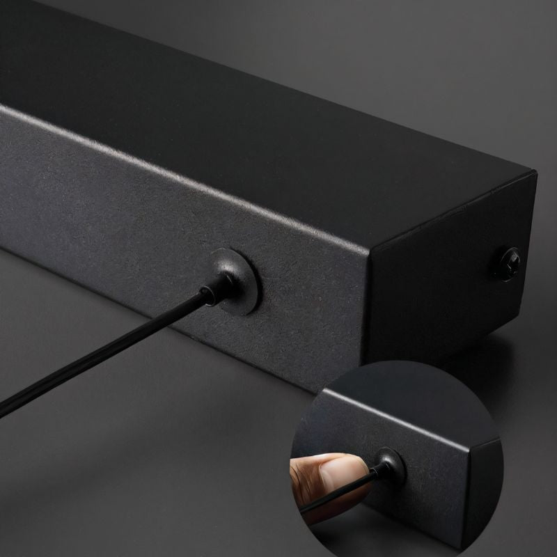 Clérachic black linear pendant detail: the end cap and cable entry point on the matte-black aluminium bar.