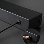 Clérachic black linear pendant detail: the end cap and cable entry point on the matte-black aluminium bar.