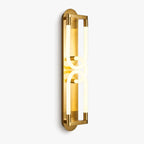 Gold wall light from Clérachic with two interlocking loops of frosted glowing tube on a slim backplate, on white.