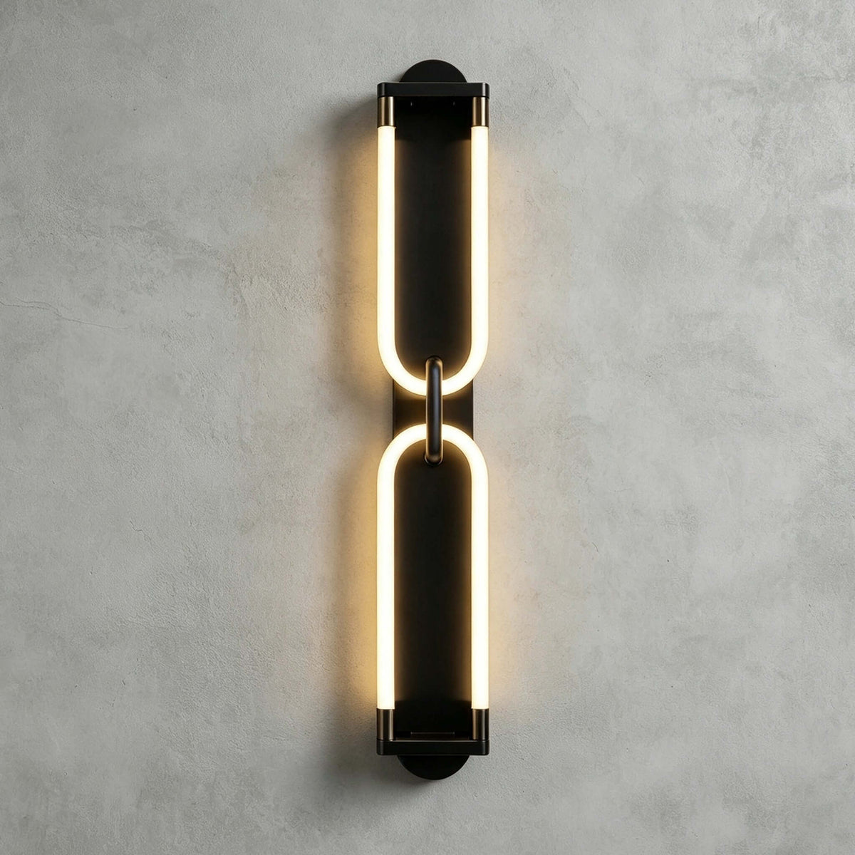 Black Clérachic wall light on a grey plaster wall, two stacked glowing loops joined at the middle by a small link.