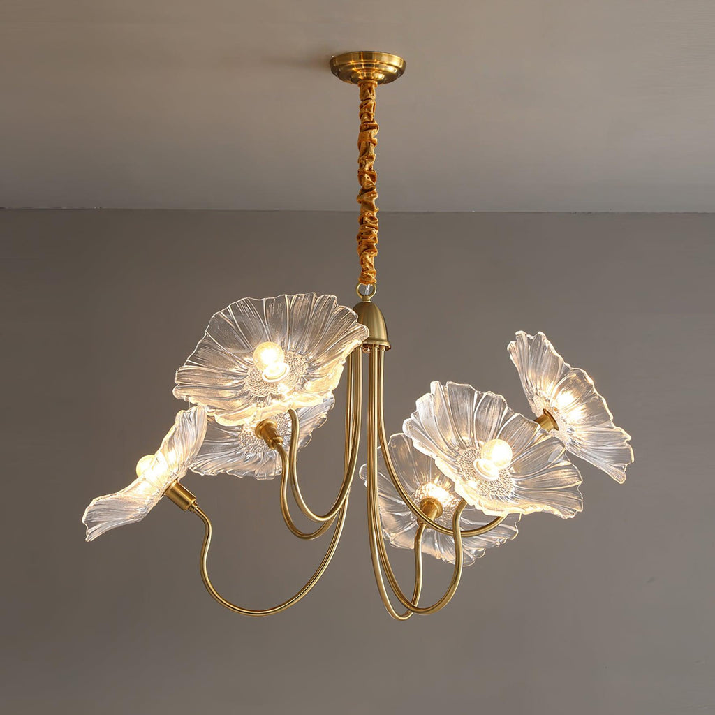 The 6-light clear glass Clérachic Lotus Blossom Chandelier, six ruffled shades fanned out and lit against a grey wall.
