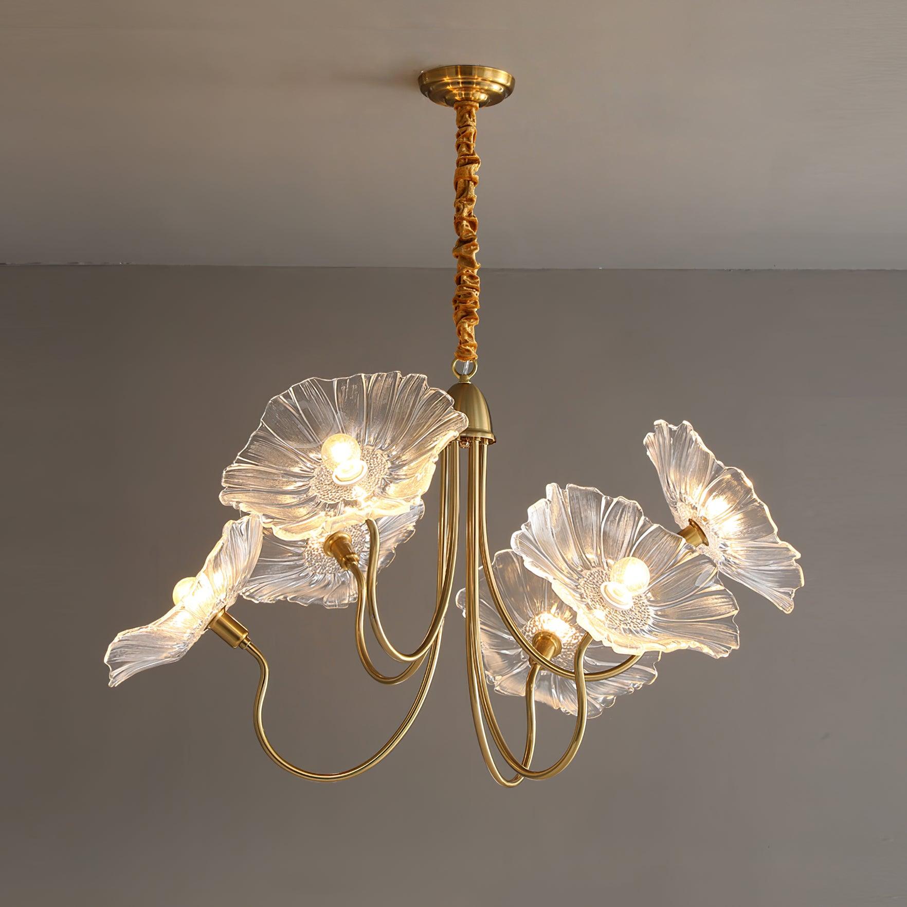 The 6-light clear glass Clérachic Lotus Blossom Chandelier, six ruffled shades fanned out and lit against a grey wall.
