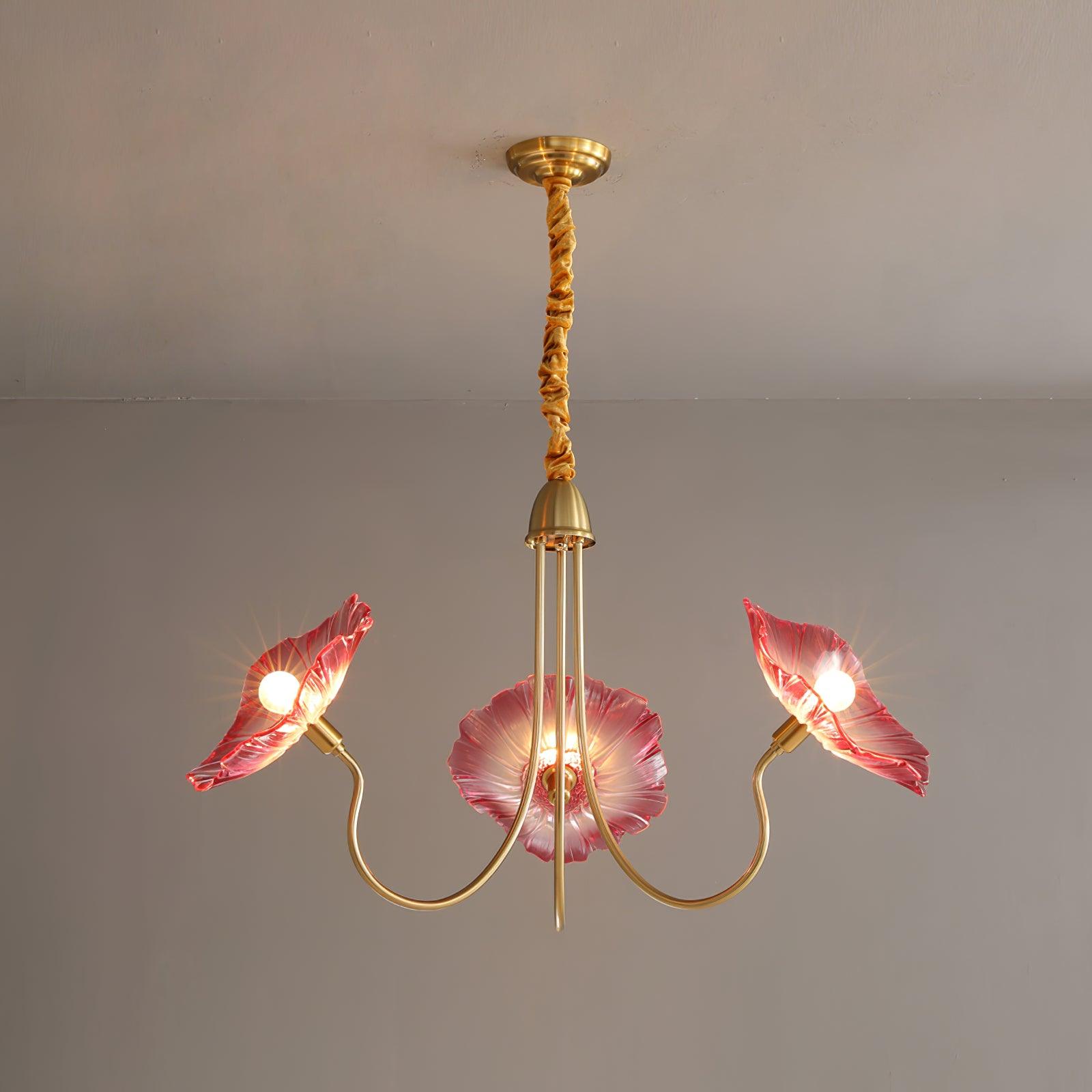 Pink glass version of the Clérachic Lotus Blossom Chandelier, 3-light, blush petal shades glowing on brass arms.