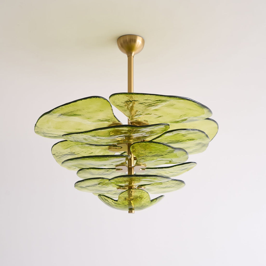 Green Clérachic Lotus Leaf Glass Chandelier seen from below, five tiers of glass leaves against a pale wall.