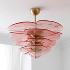 Pink Clérachic lotus leaf chandelier on a ceiling near a white curtain, its five tiers of leaves fanning out.