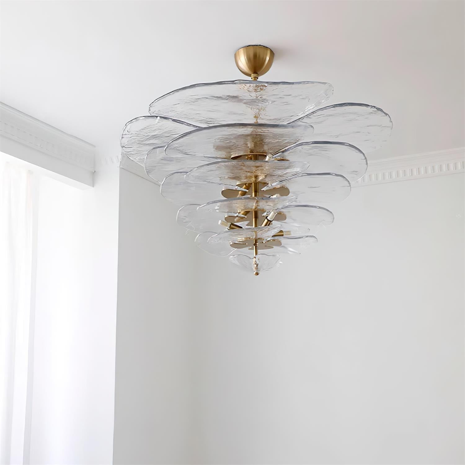 Clear Clérachic Lotus Leaf Glass Chandelier lit in a corner with white cornice moulding and daylight nearby.