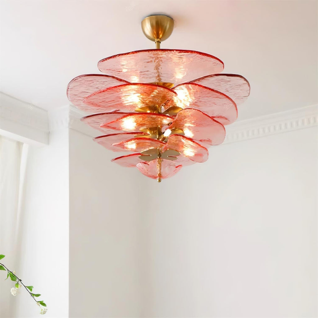 Pink Clérachic lotus leaf chandelier lit on a white ceiling, the glow spreading through five stacked leaf tiers.