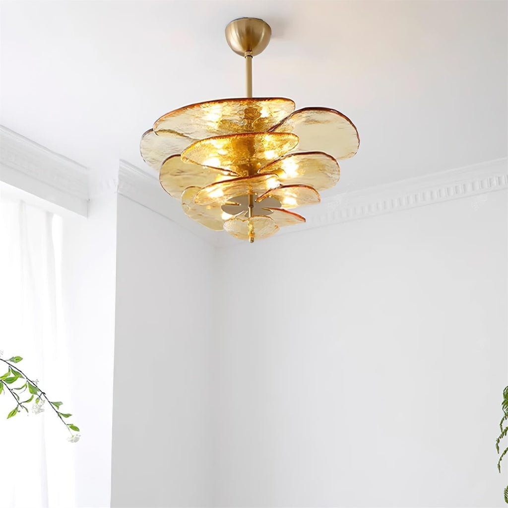 Amber Clérachic lotus leaf chandelier lit in a corner with cornice moulding and daylight from a nearby window.