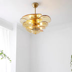 Amber Clérachic lotus leaf chandelier lit in a corner with cornice moulding and daylight from a nearby window.