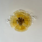 Amber Clérachic Lotus Leaf Glass Chandelier seen straight from below against a ceiling with plaster scrollwork.
