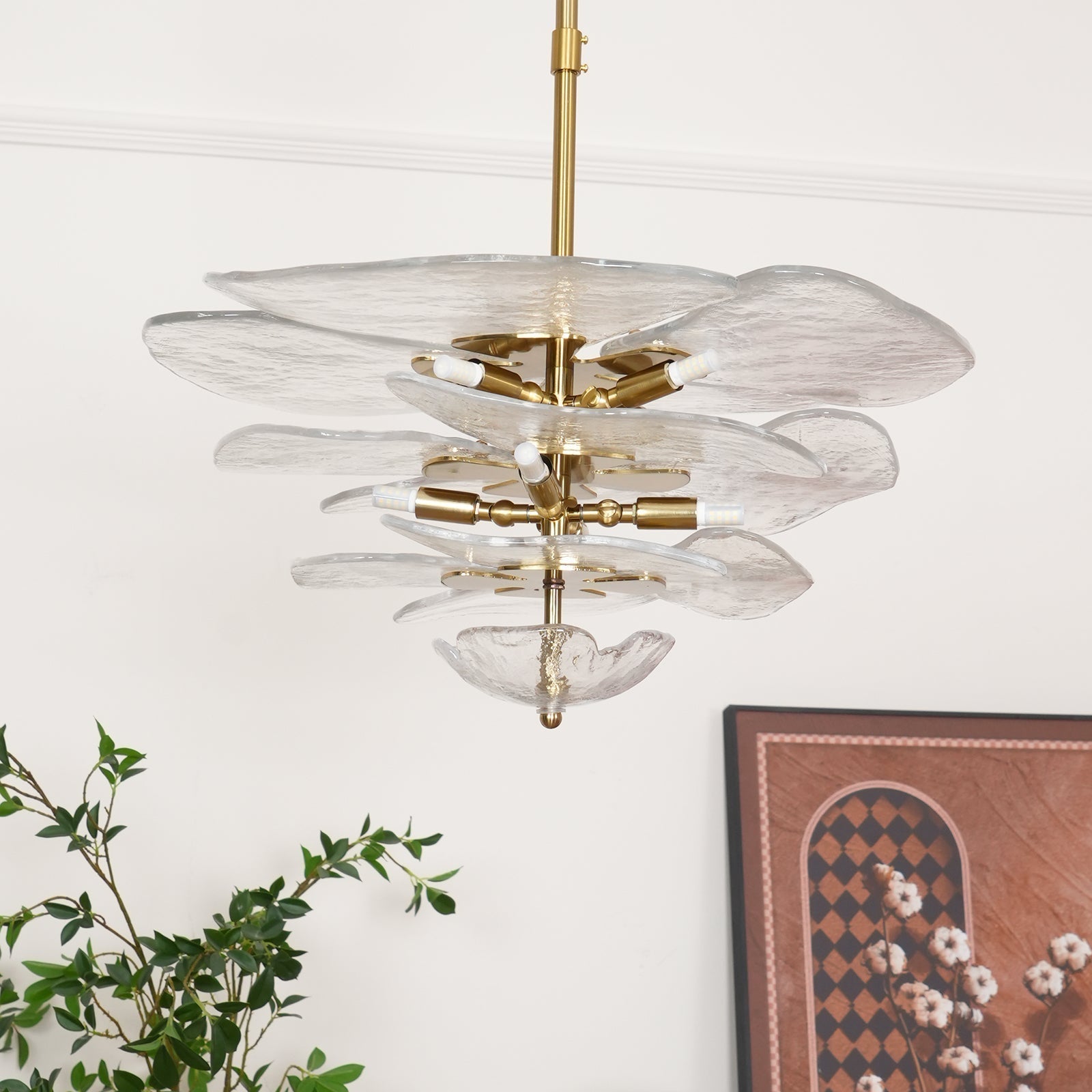 Unlit clear Clérachic lotus leaf chandelier on its brass rod, the E14 sockets visible between the glass tiers.