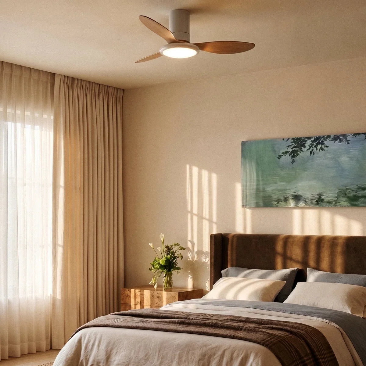 Clérachic white and wood ceiling fan with a light above a bed in a calm bedroom with sheer curtains and a warm lit disc.